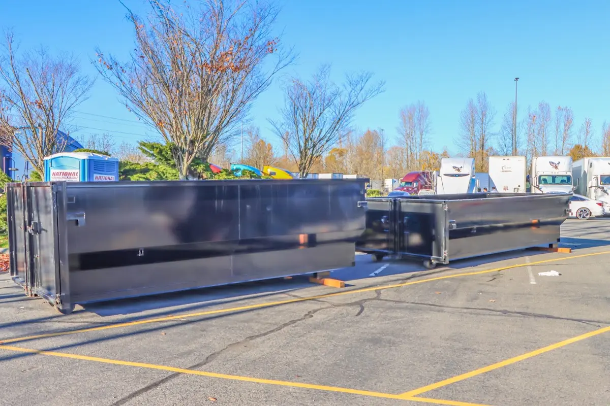 Professional dumpster rental service with roll-off container on residential driveway in Linganore